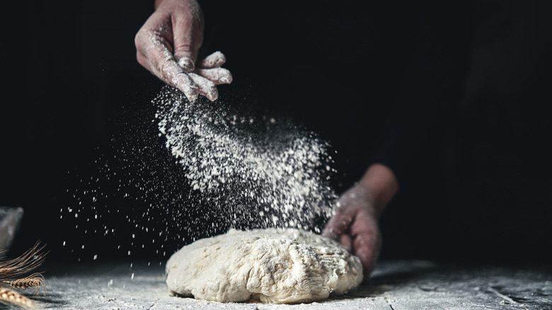 Sprinkling flour on dough