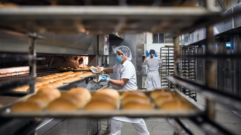 Baker wearing protective mask in factory