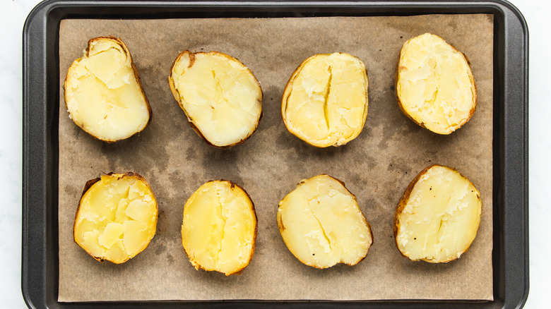 Potatoes halved on baking sheet