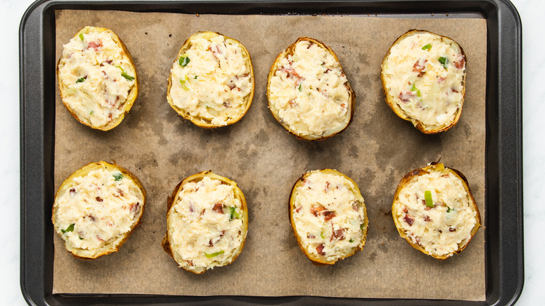 Filled potato skins on baking sheet