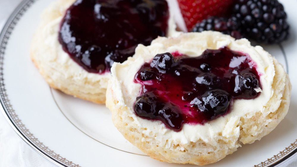 British scones on plate with strawberries jam and clotted cream