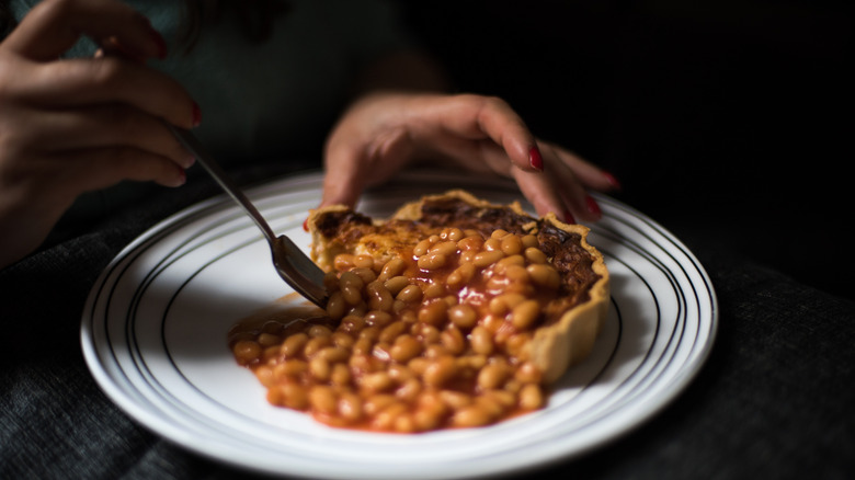 eating plate of baked beans