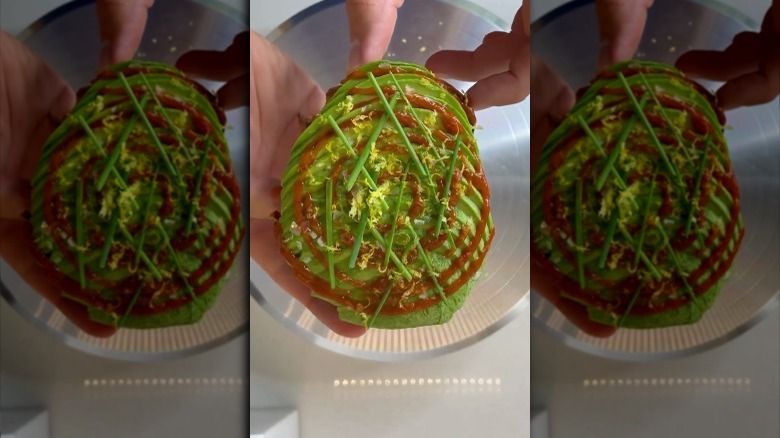 A man holding an avocado toast 