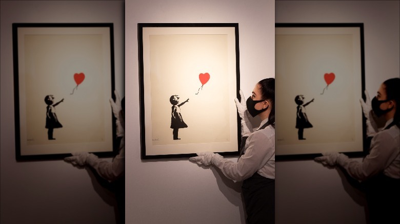 Banksy's "Girl With Balloon" being hung