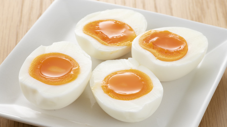 Soft boiled eggs on white plate