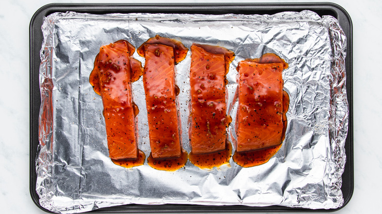Sweet chili salmon on baking sheet