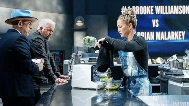 Brooke Williamson cooking in front of Guy Fieri