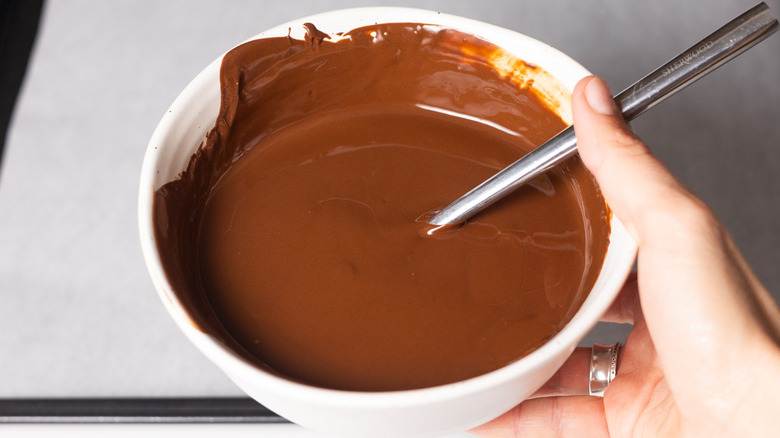 hand holding melted chocolate