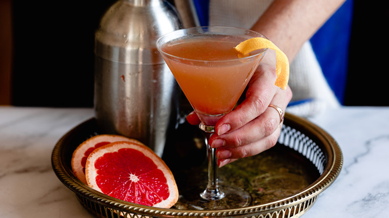 hand serving brown derby cocktail