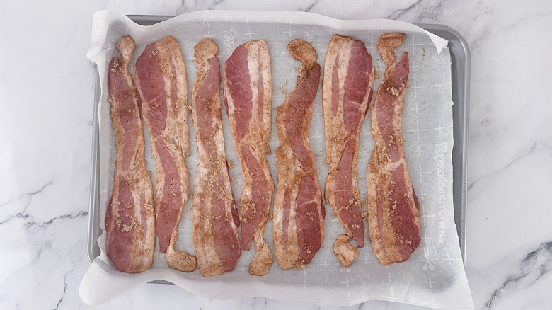 bacon strips on baking sheet