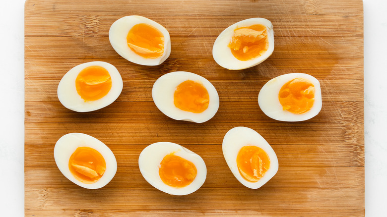 halved boiled eggs on cutting board