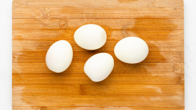 peeled boiled eggs on cutting board