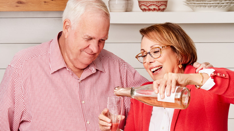 Babs pouring wine with her husband