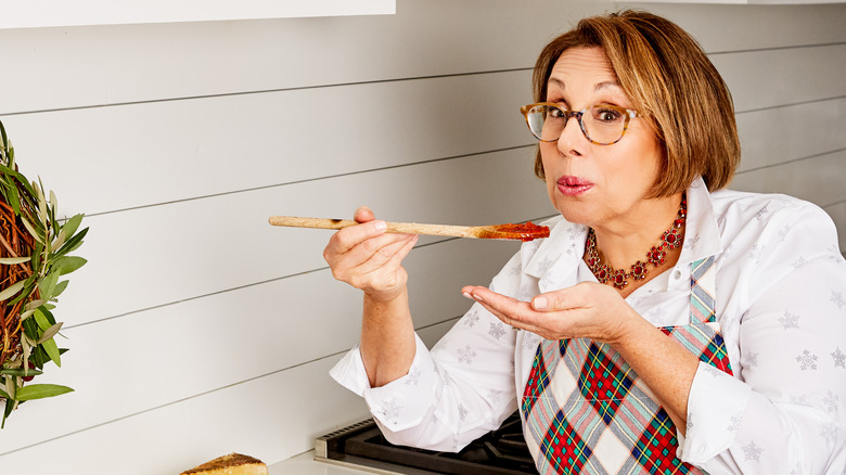 Babs tasting food in kitchen