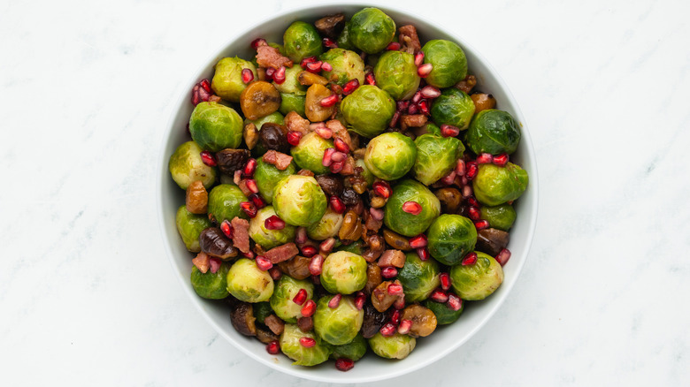 Bacon chestnut sprouts with pomegranate in bowl