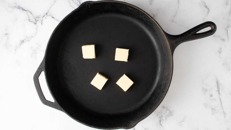 butter chunks in black pan