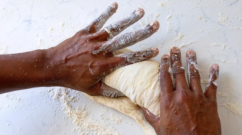 hands kneading dough