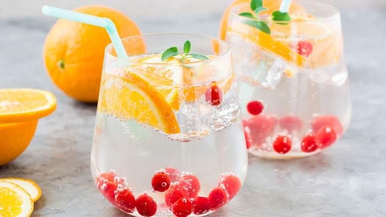 Clear glasses of seltzer with cranberries