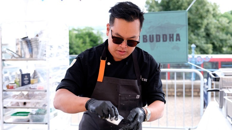 Buddha Lo cooks with sunglasses