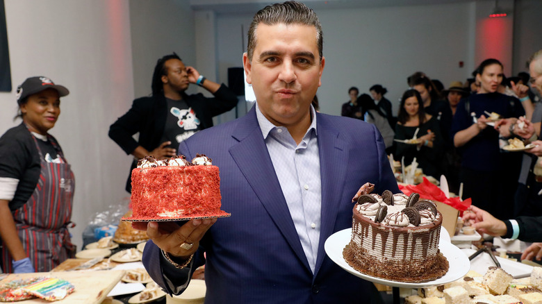 Buddy Valastro holding up cakes