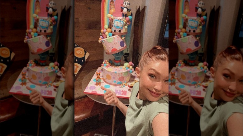 Gigi Hadid taking a selfie with a birthday cake made by Buddy Valastro