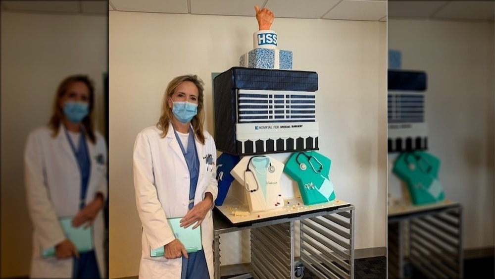 Dr. Michelle Carlson posing with cake