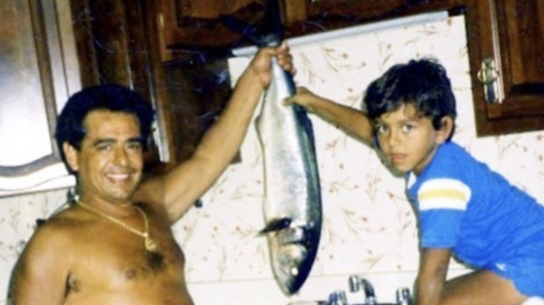 A young Buddy Valastro with his father holding fish