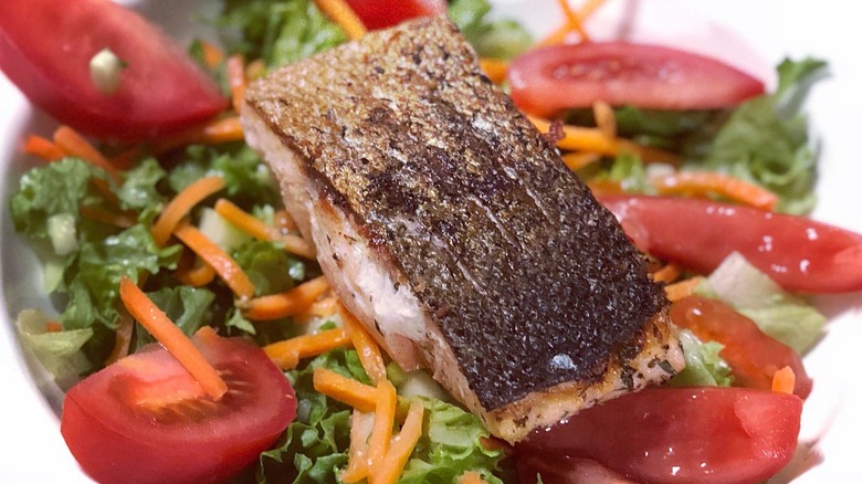 Skin-on salmon filet on salad