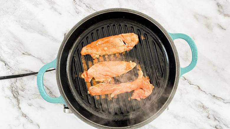 chicken cooking on grill pan