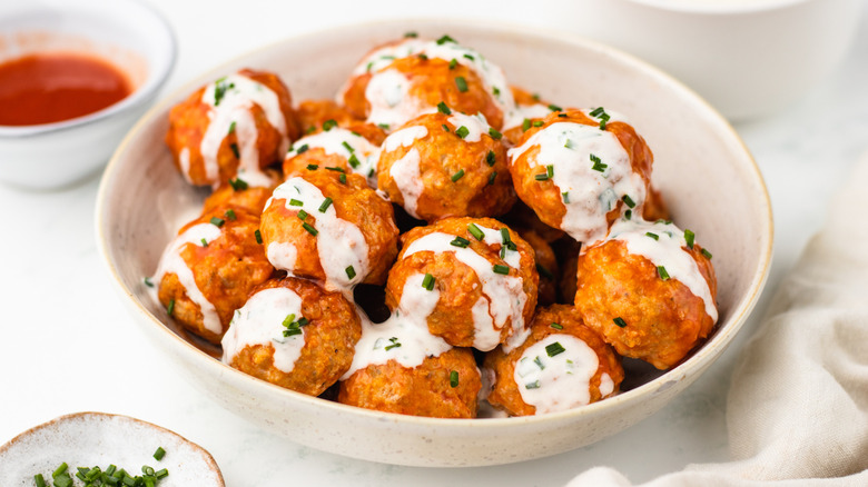 Bowl of buffalo chicken meatballs with ranch sauce