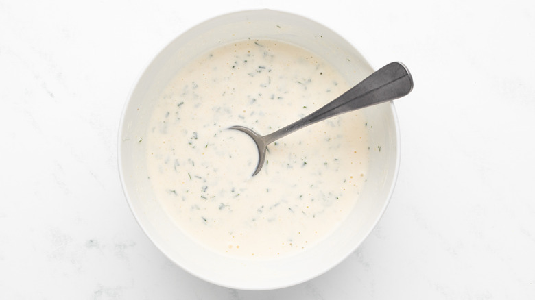 Ranch sauce in white bowl with spoon