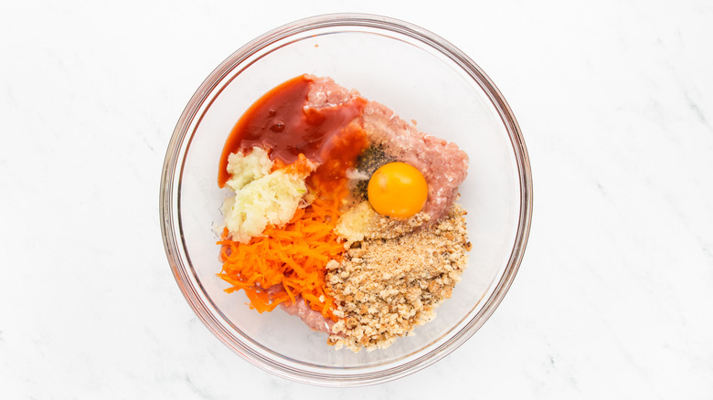 Buffalo chicken meatball ingredients in glass mixing bowl