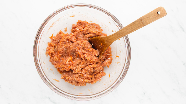 Buffalo chicken meatball mixture in large glass bowl