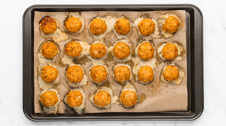 Baked buffalo chicken meatballs on baking sheet