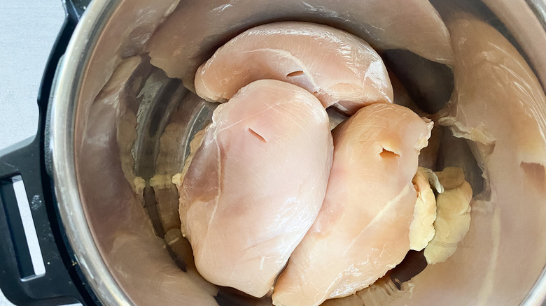 Raw chicken in pot