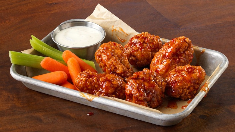 Tray of hot wings with ranch dressing, celery, and carrots