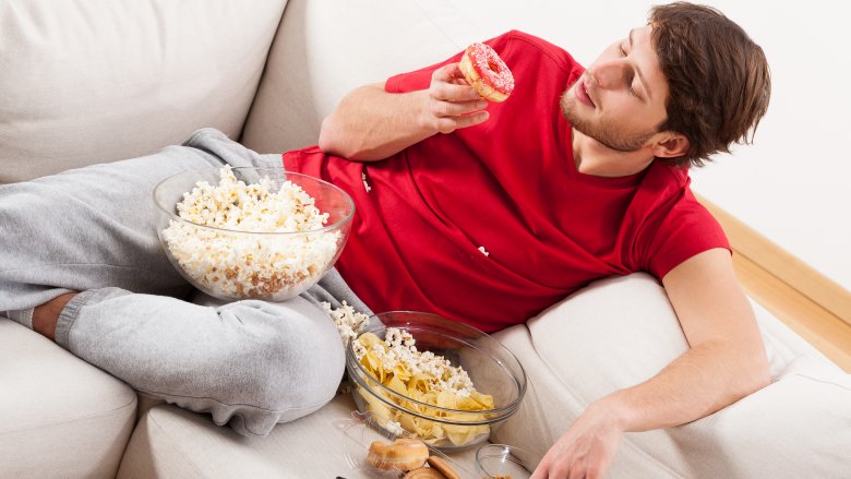 guy in sweats pigging out 