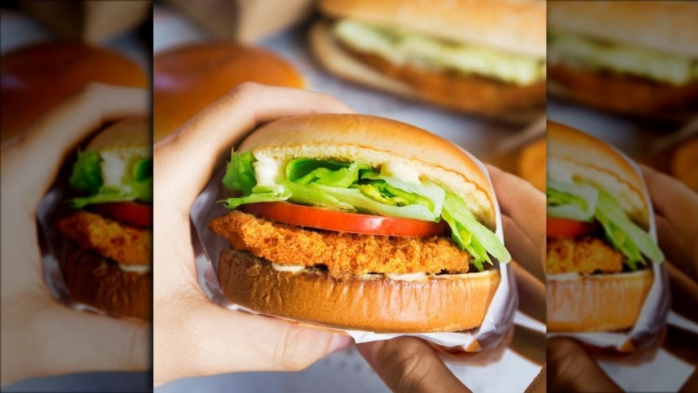 Hand holding the old Crispy Chicken Sandwich