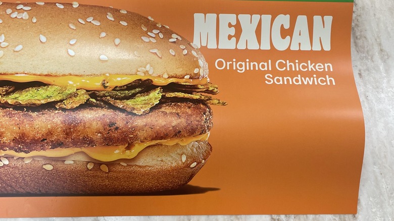 A photo taken of a promotional image of the new Mexican orignal chicken sandwich at Burger King