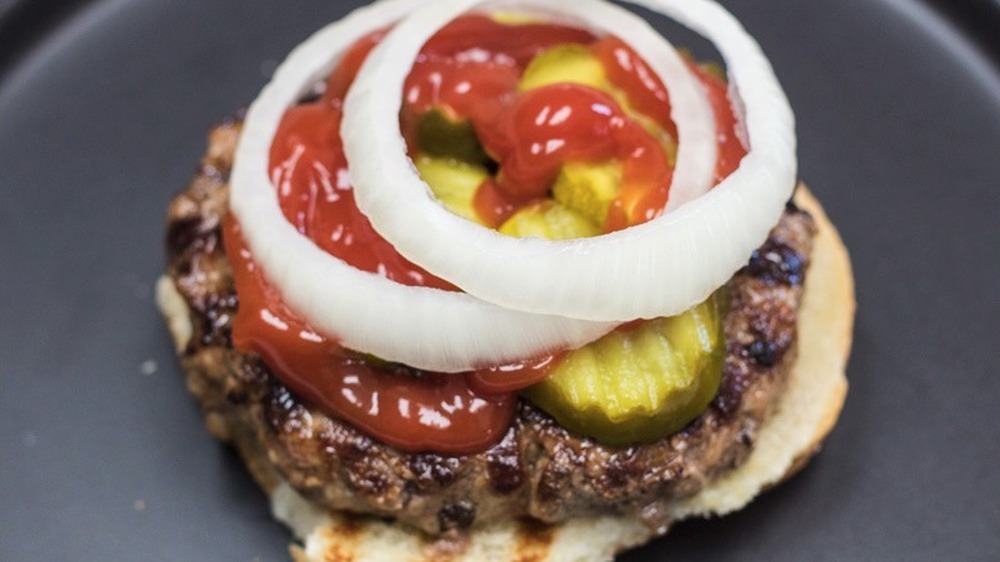 stacking ingredients on a hamburger