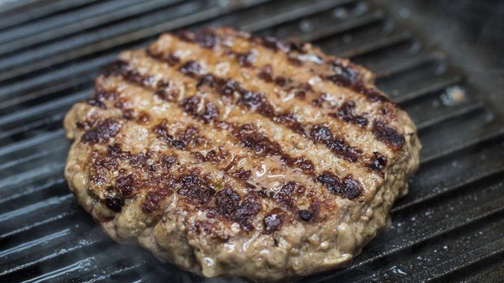 a burger patty cooking