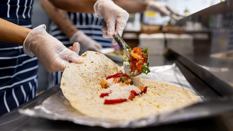 chef assembling burrito