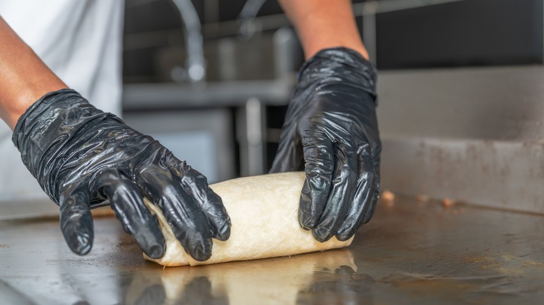 burrito being placed on griddle