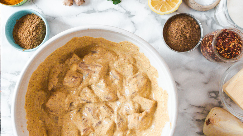 chicken marinating in a bowl