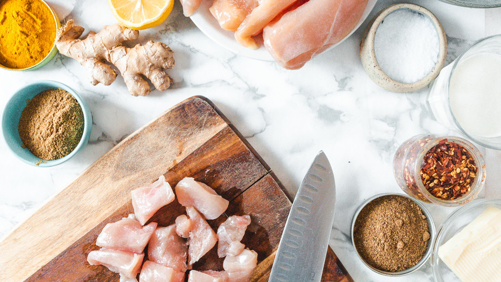 diced chicken on cutting board with spices