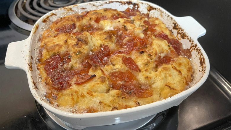 Baked biscuits with jam in baking dish