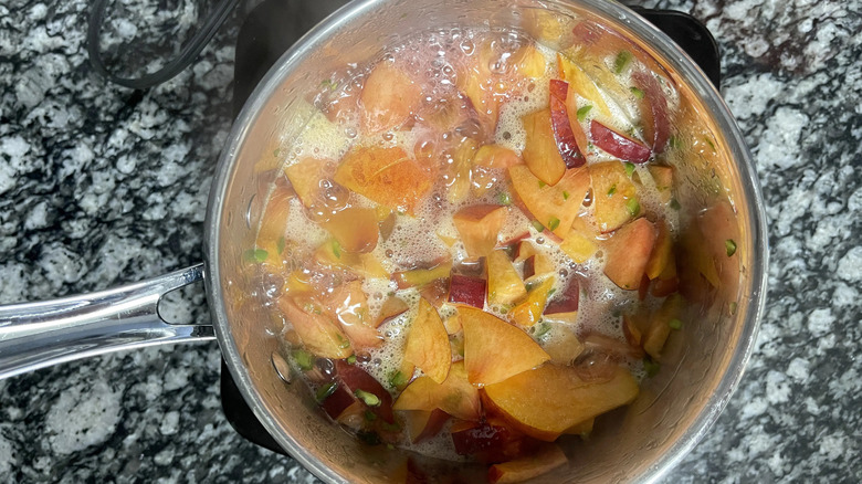 Peaches and jalapeno simmering in saucepan