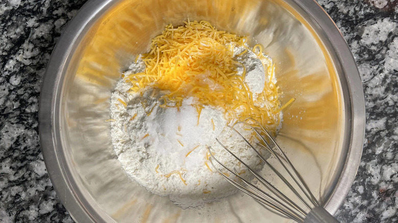 Cheddar, flour, and whisk in bowl