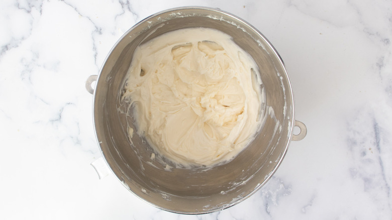 whisked cream cheese frosting in bowl