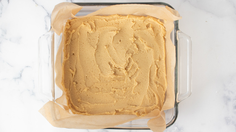 blondie batter layer spread in prepped baking dish